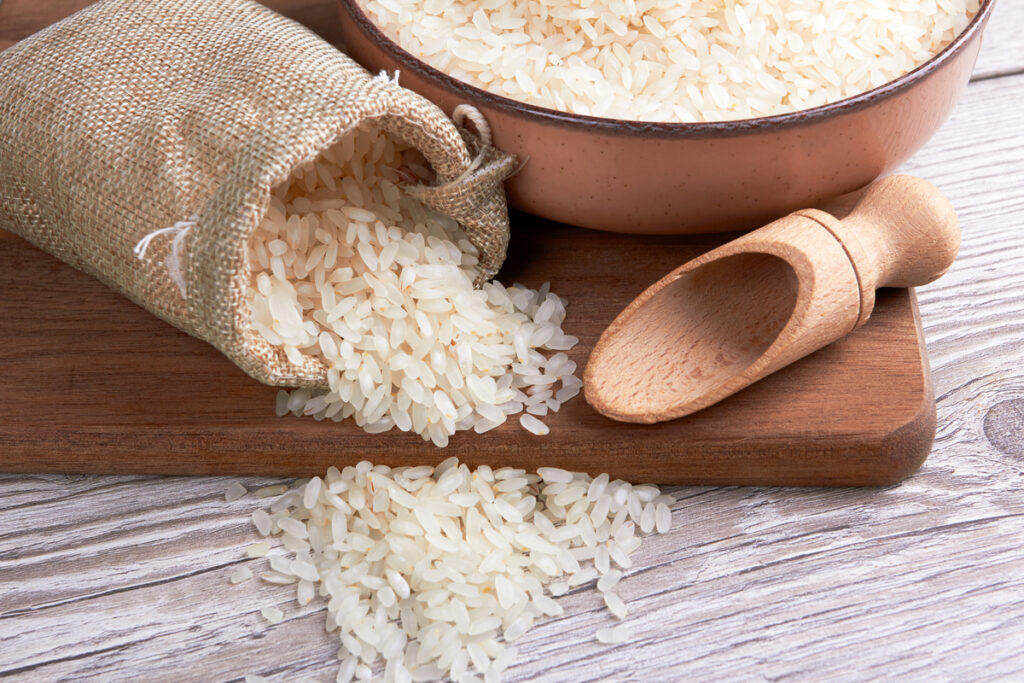 Rice in bowl on a wooden background