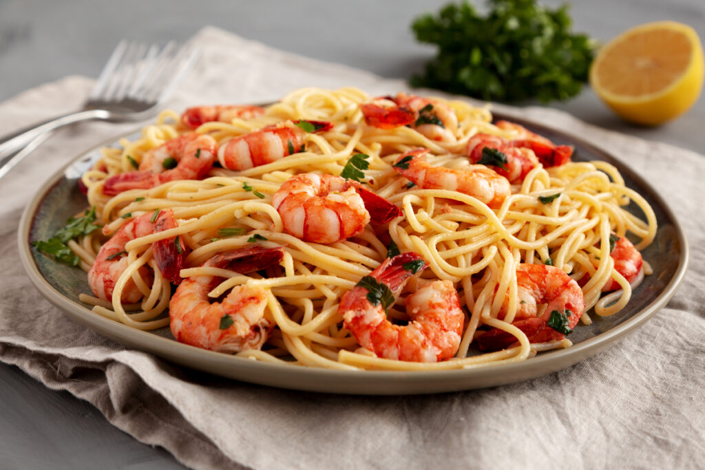 Homemade Cooked Garlic Shrimp Scampi on a Plate, side view. Close-up.