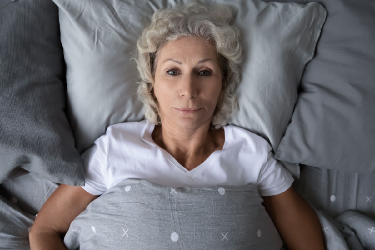 woman laying awake in bed at night