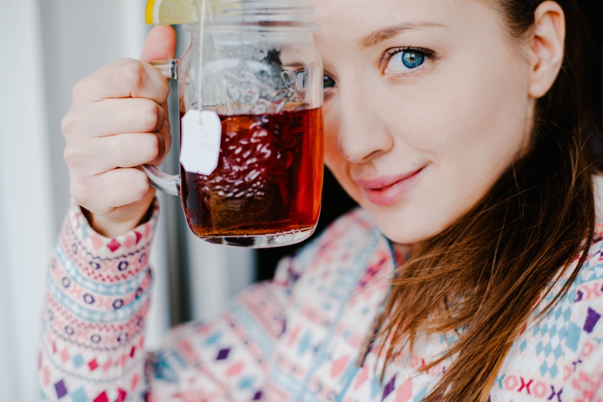 Woman drinking tea with lemon