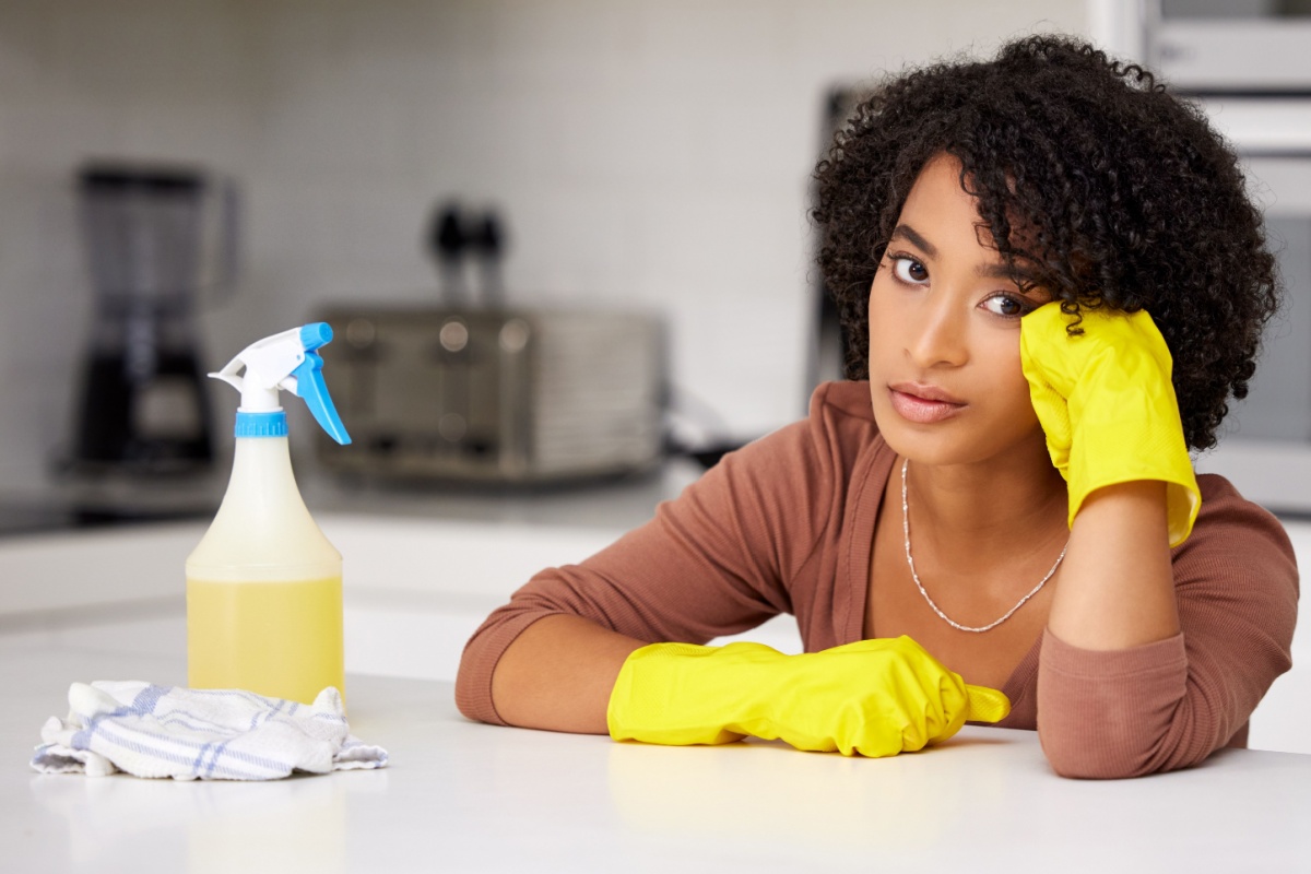 annoyed woman cleaning kitchen frustrated