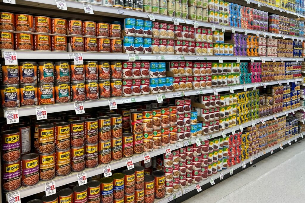 canned beans on the shelves in a supermarket