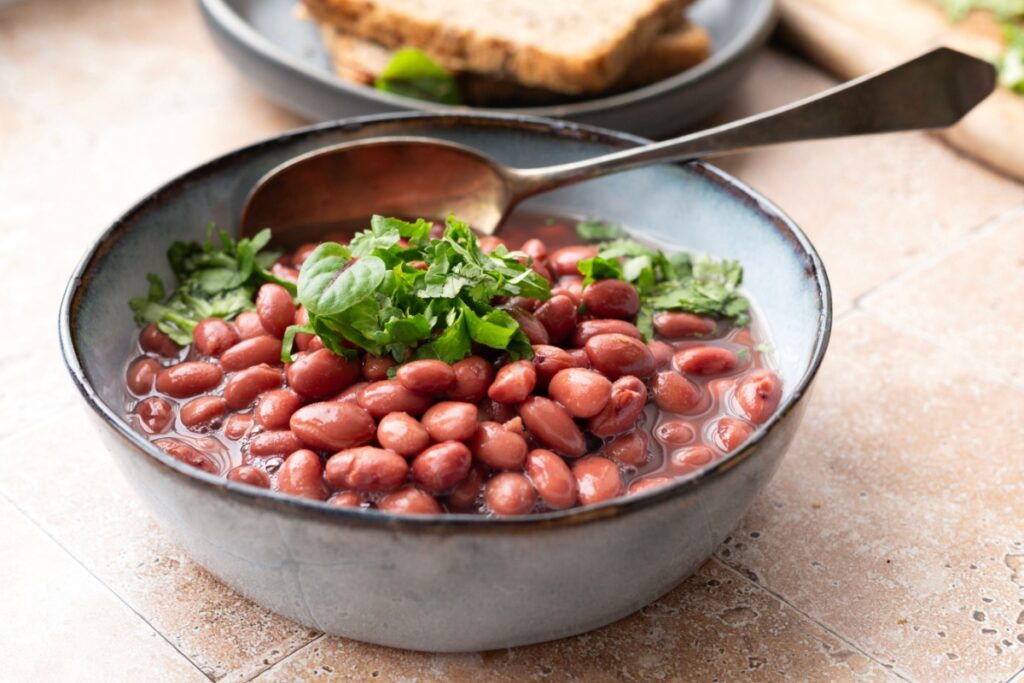 cooked Kidney beans in bowl with spoon