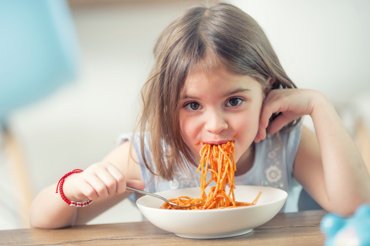 cute kid eating spaghetti leftovers