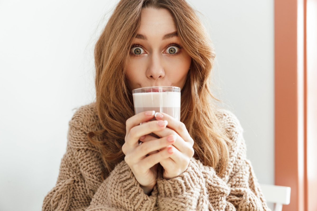 excited woman drinking coffee latte