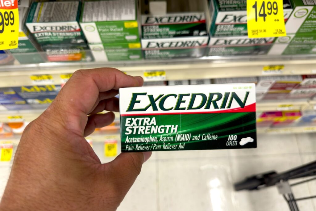 hand holding a package of Excedrin over-the-counter pain reliever