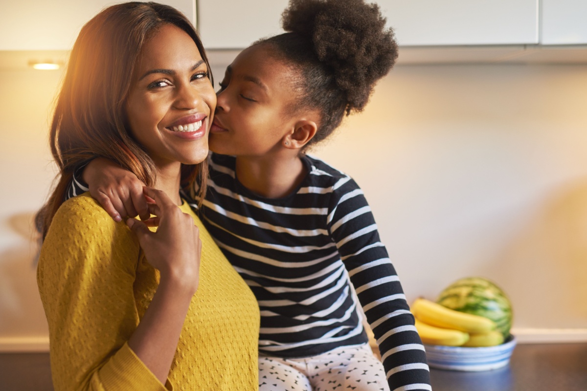 happy mom and daughter in kitchen