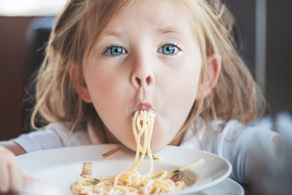 little girl kid eating pasta spaghetti