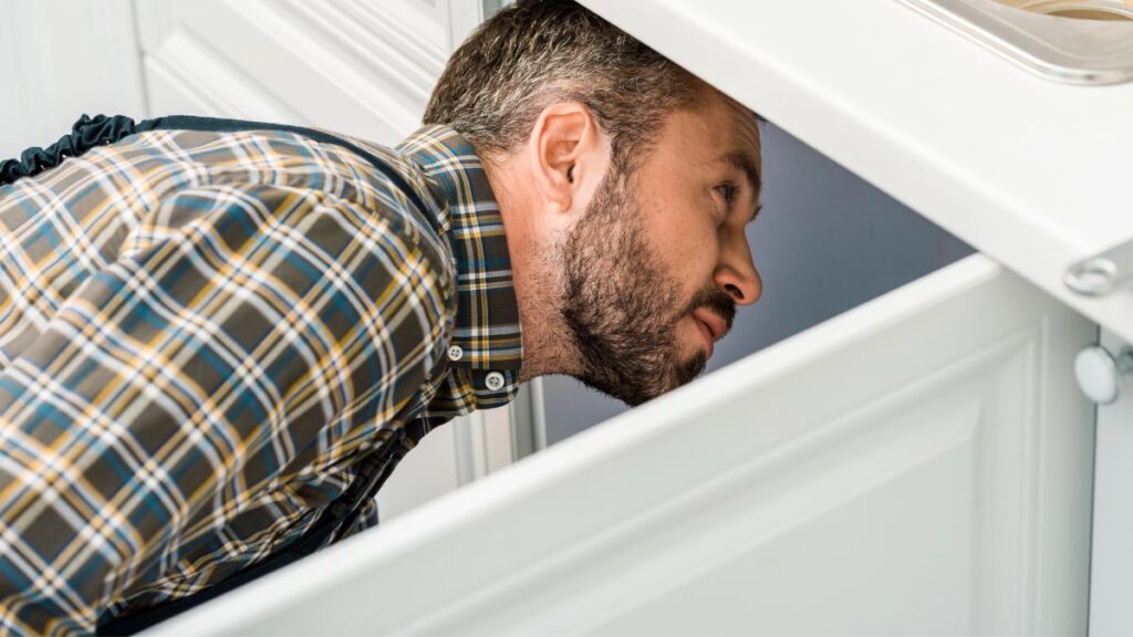 man under the sink