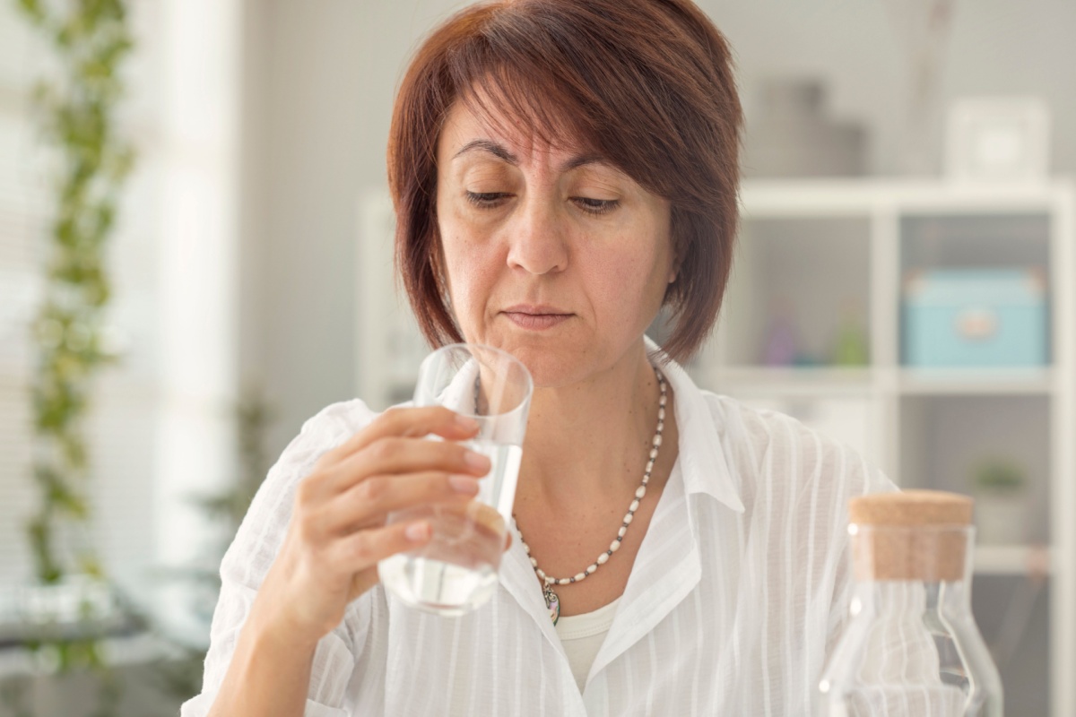 middle aged mature woman suspicious looking at water