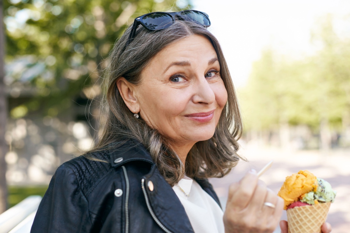 middle aged mature woman eating ice cream