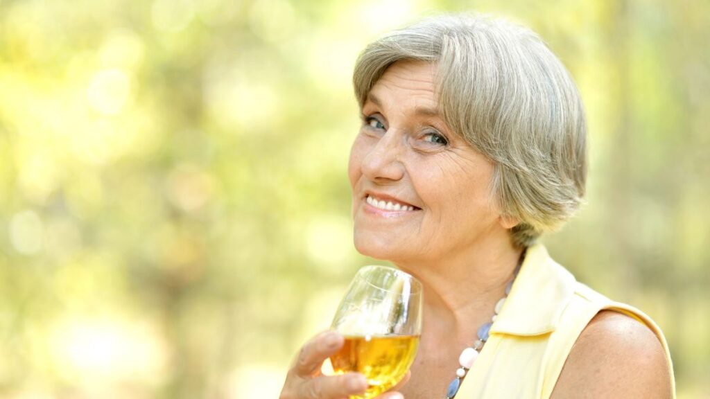 older woman drinking wine