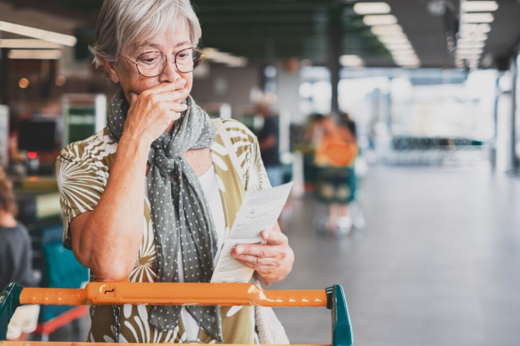 senior woman grocery receipt broke 