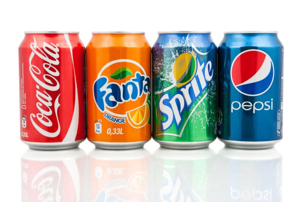 soda pop Coca-Cola, Fanta and Sprite cans with Pepsi can