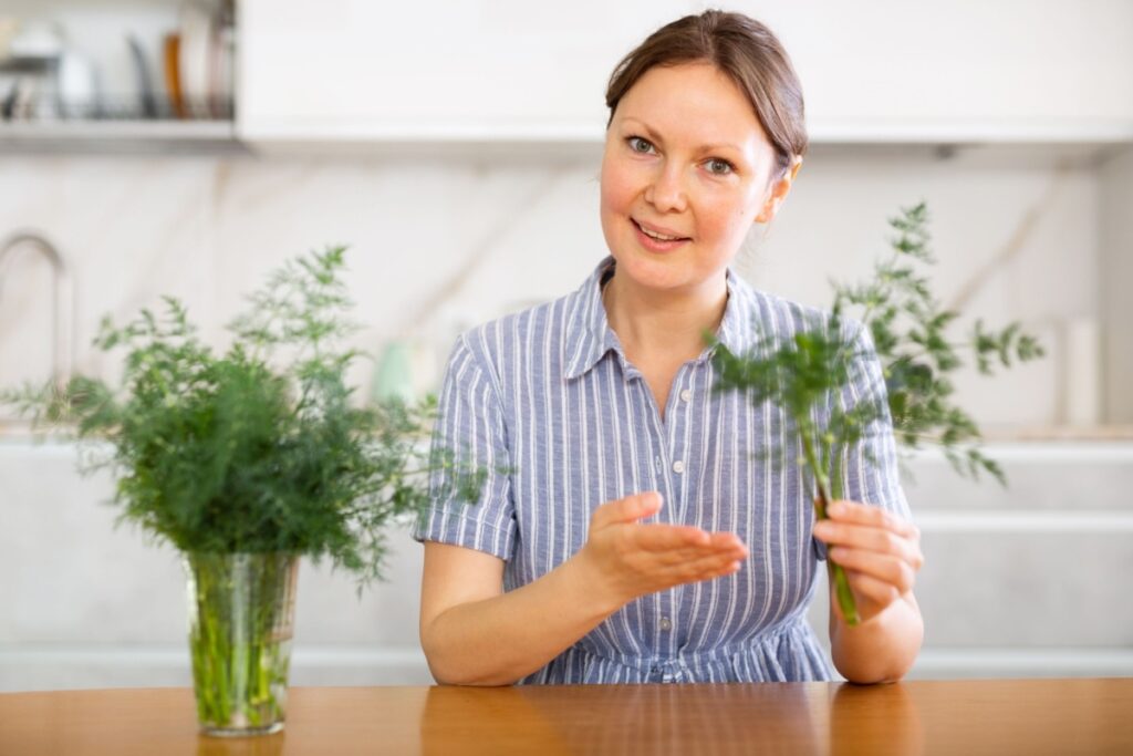 woman growing herbs dill