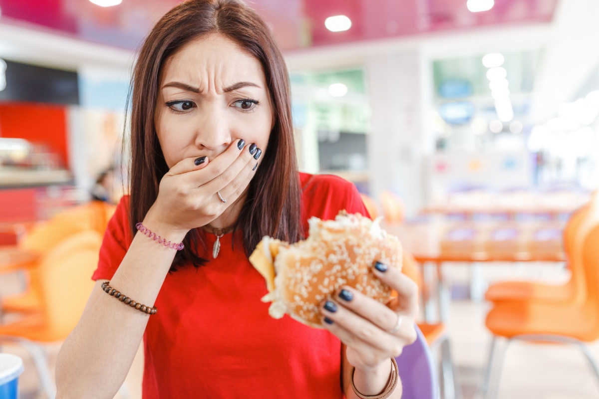 woman holding burger spoiled bad