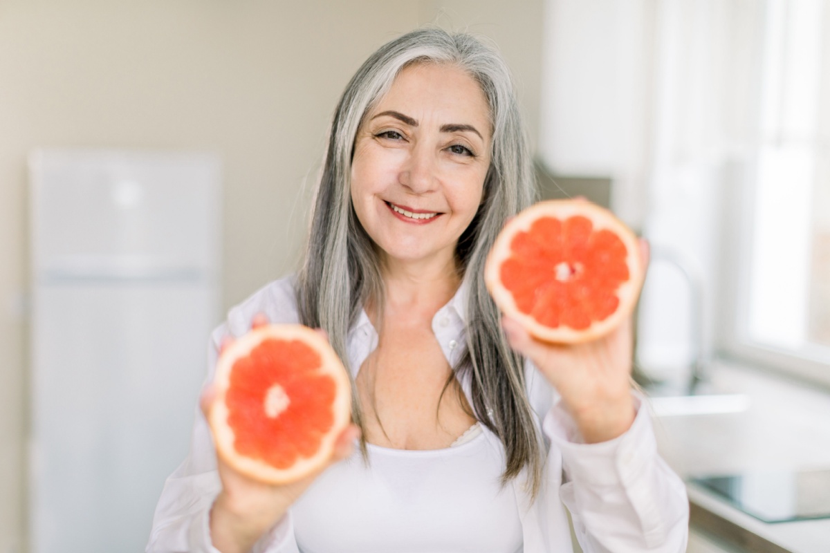 woman holding grapefruit