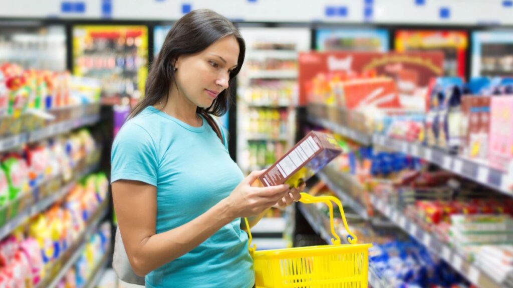 woman in grocery store looking at box