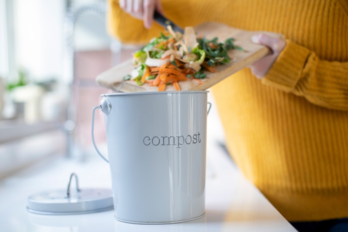 woman kitchen compost bin