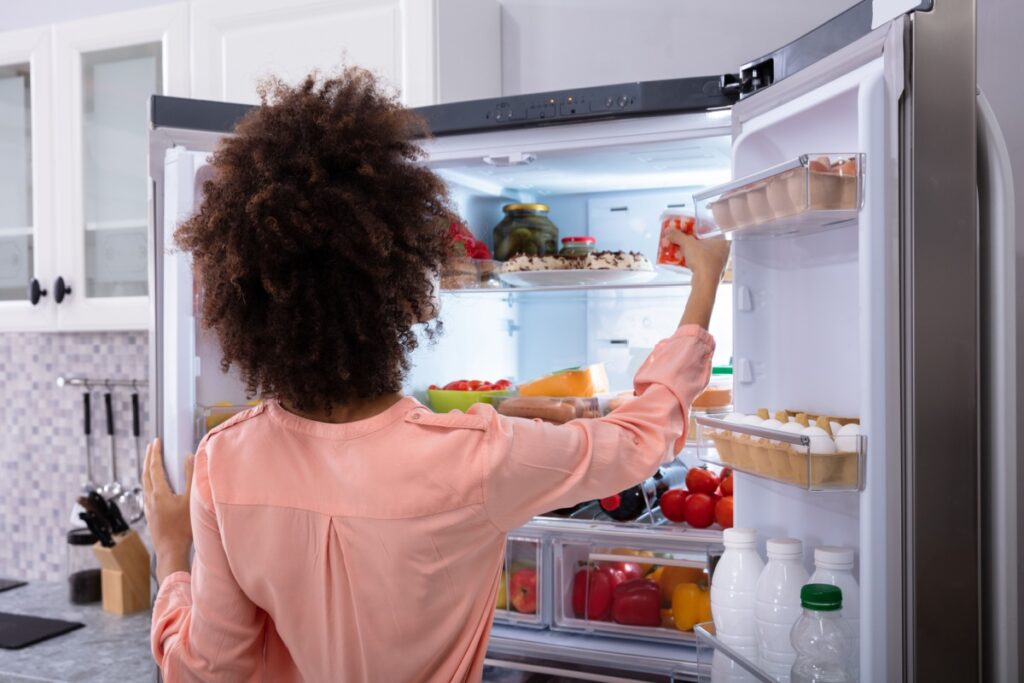 woman looking in her fridge