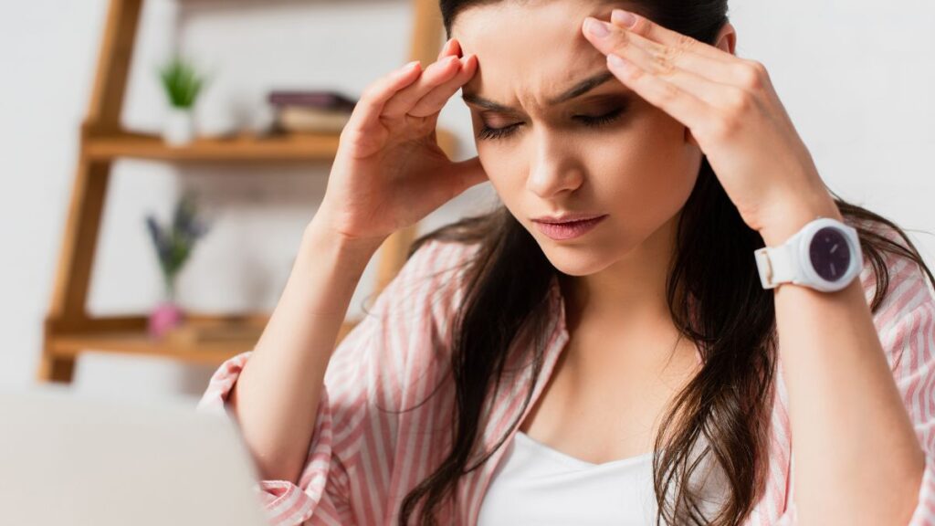 woman looking stressed at computer