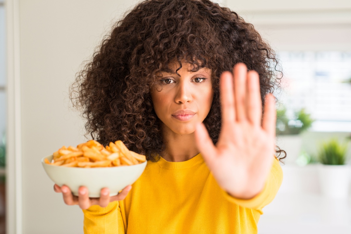 woman saying no to French fries chips