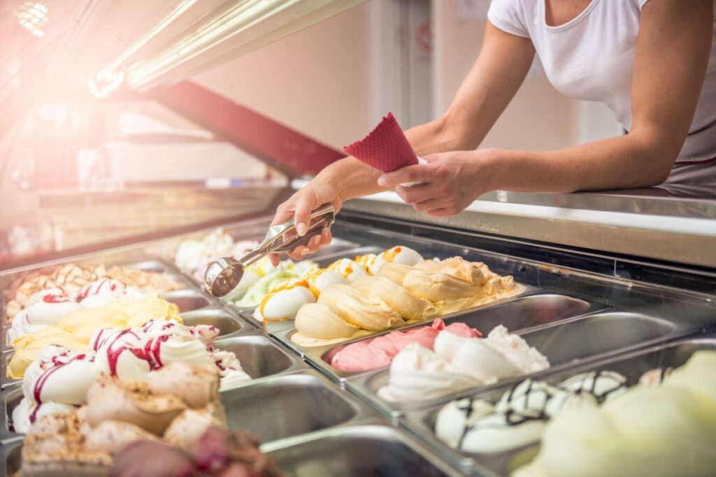 woman scooping ice cream shop