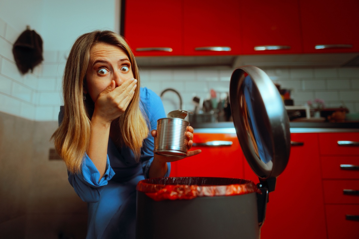 woman throwing out rotting food smell