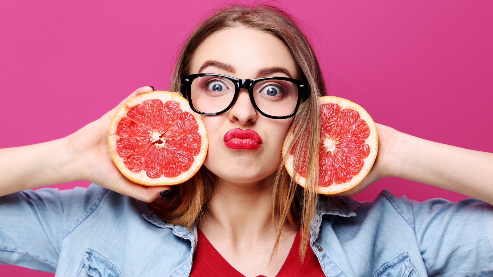 woman with grapefruit and glasses