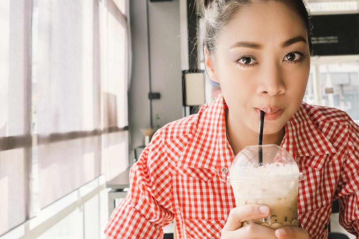 Asian woman is drinking ice coffee