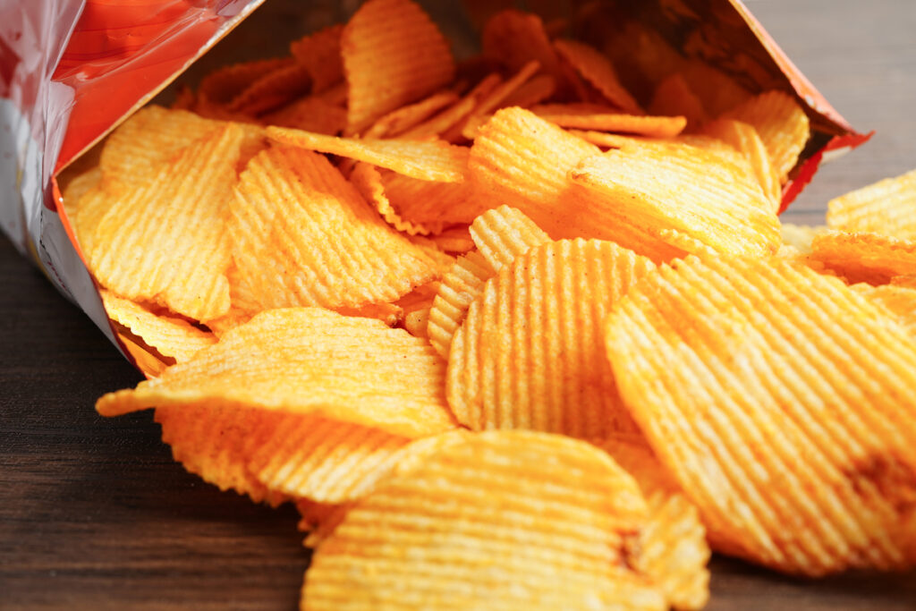 Potato chips in open bag, delicious BBQ seasoning spicy for crips, thin slice deep fried snack fast food.