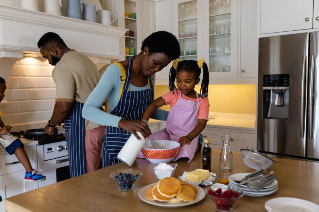 Black family making pancakes family time