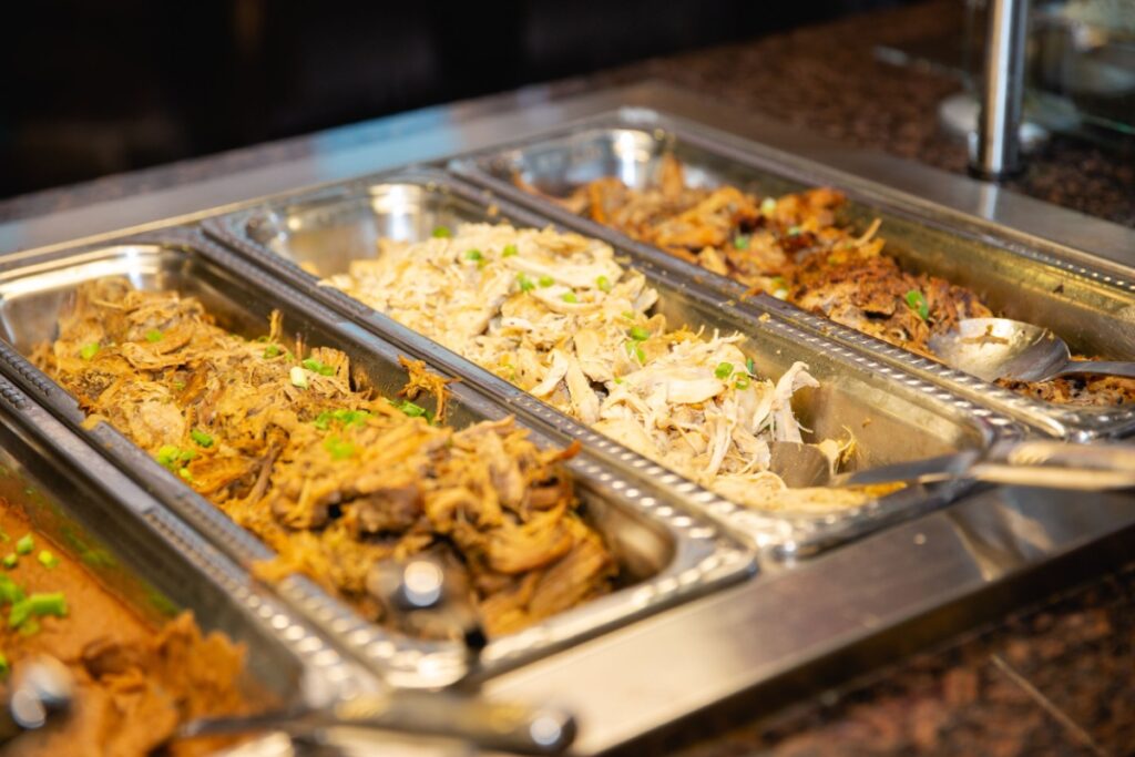 Buffet line for taco bar with various meats