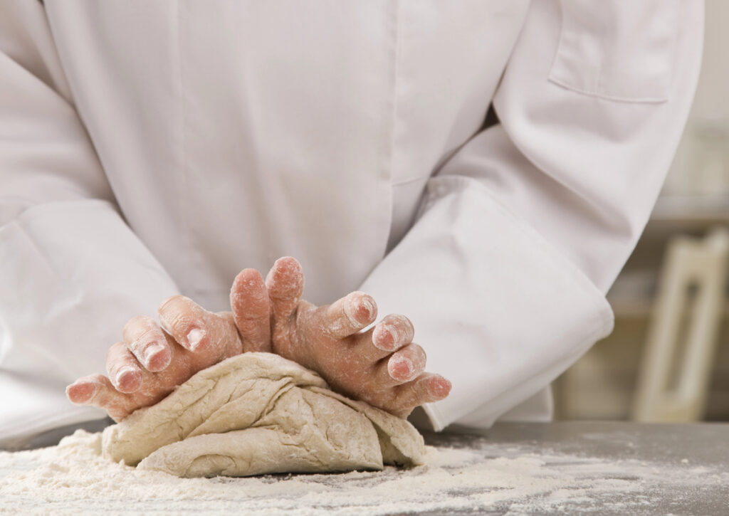 Chef kneading dough