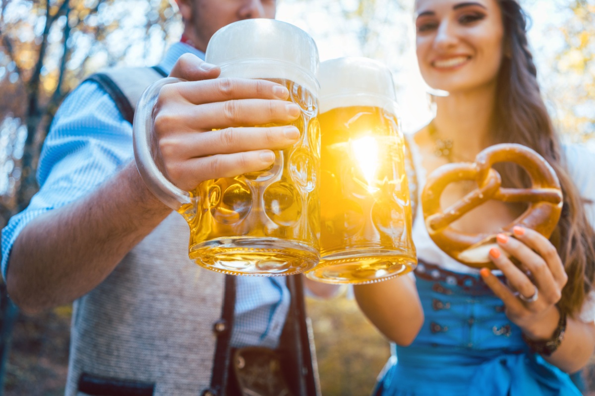 Couple toasting with beer in Bavaria in fall Octoberfest