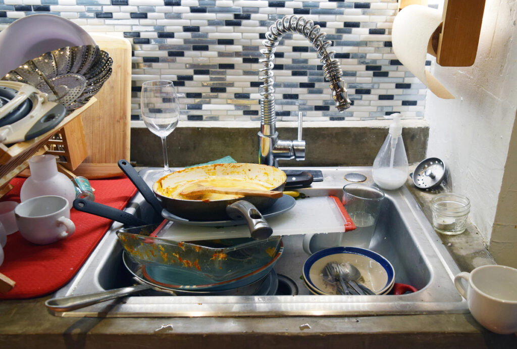 Dirty sink in a messy kitchen