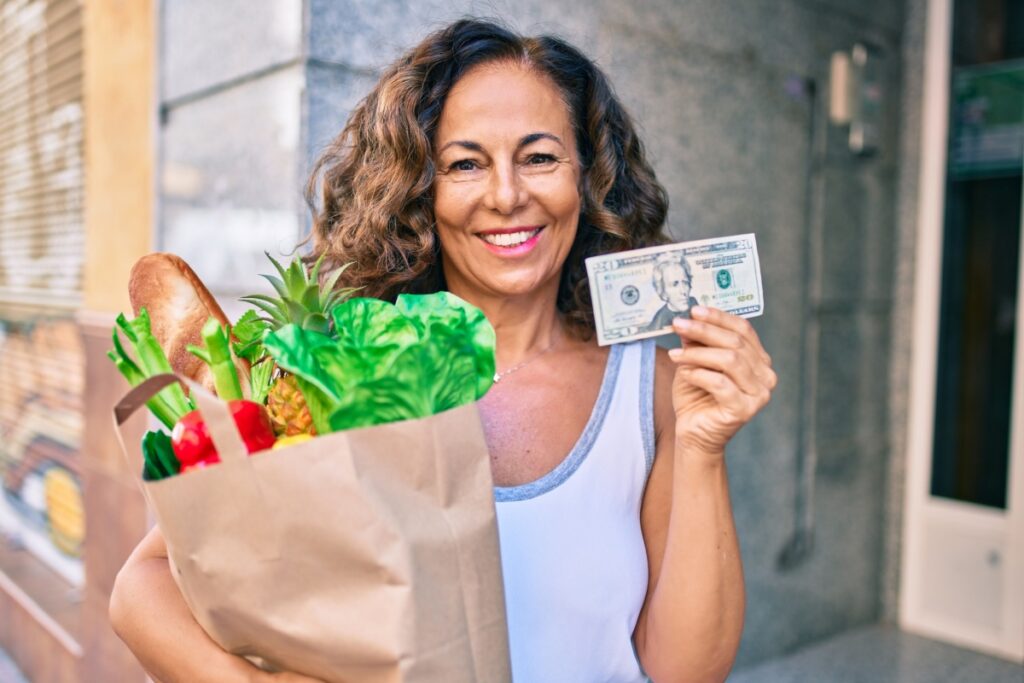 Middle aged Hispanic woman save money on groceries