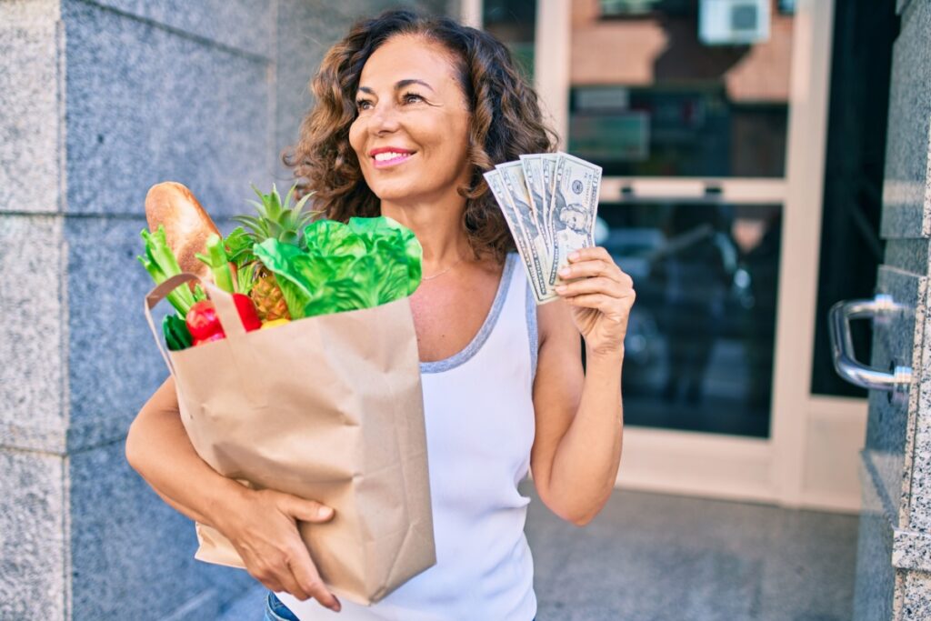 Middle aged Hispanic woman saving money on groceries