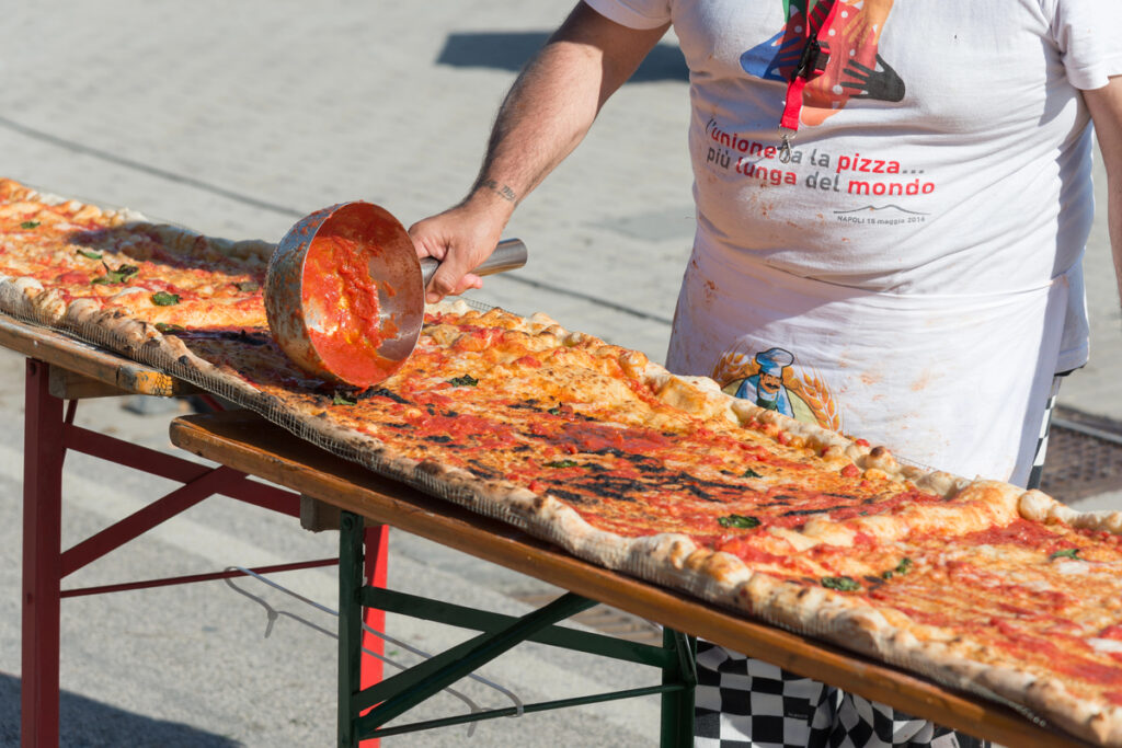 NAPLES, ITALY- MAY 18: 250 pizza chefs from around the world in Naples beat the Guinness world record for long pizza margherita circa 2 Km on  may 18, 2016 in Naples