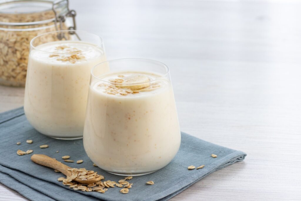 Vegan oatmeal smoothie with banana in glass jar