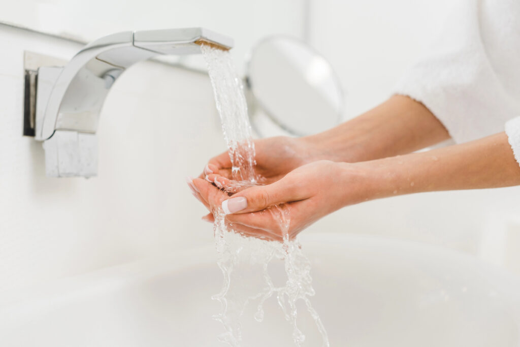 Partial view of woman washing hands at home