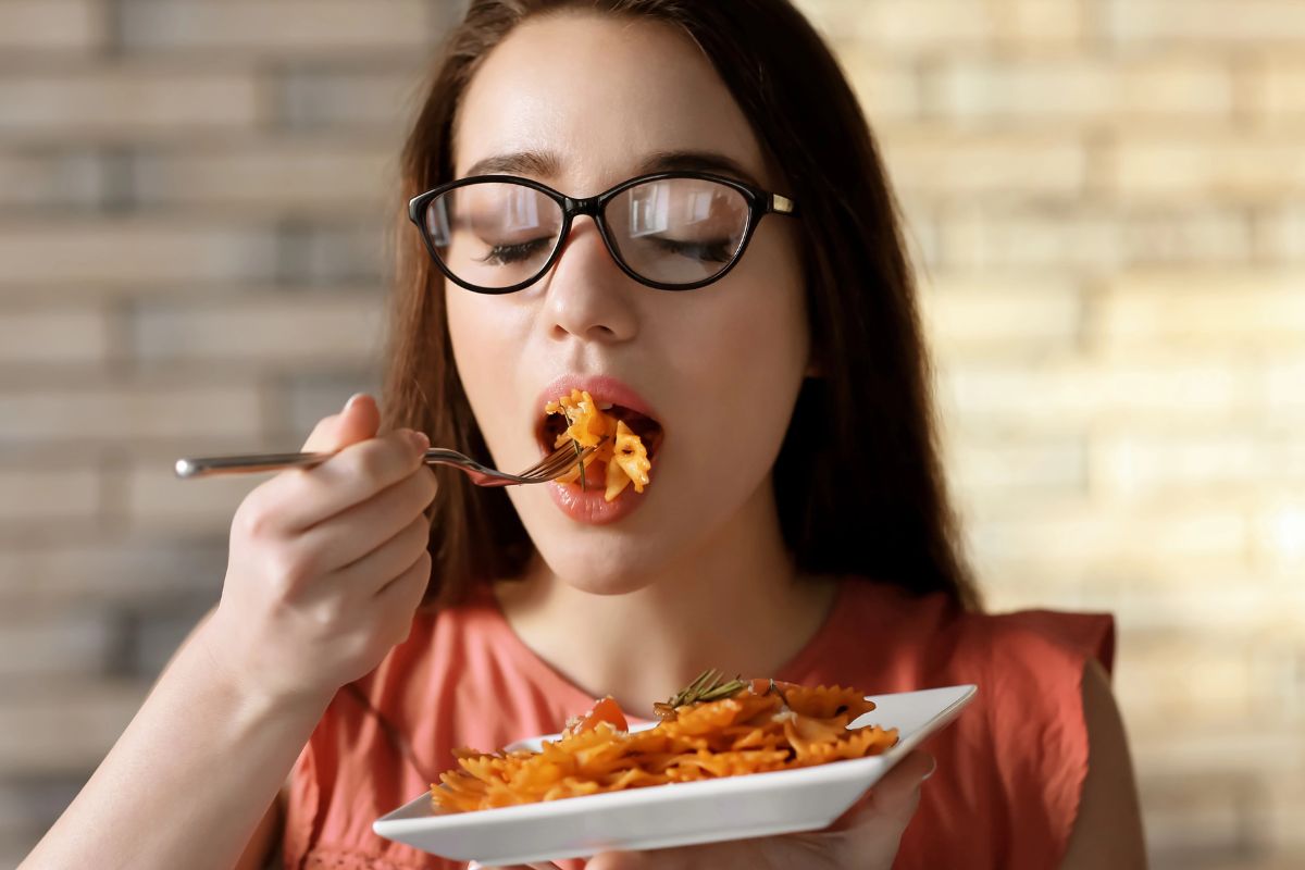 Woman eating pasta