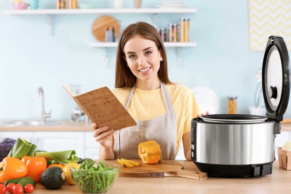 Woman  cooking modern multi cooker