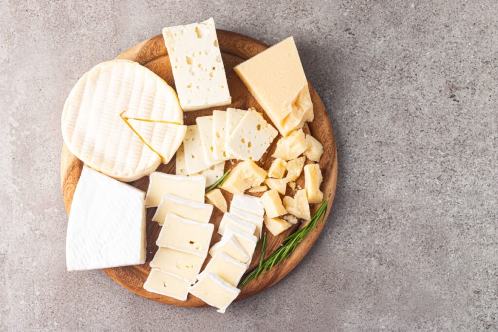 Wooden board with various cheeses