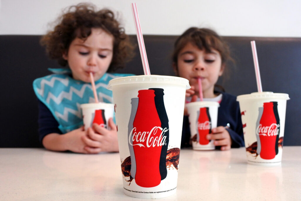 Young girls drinking Coca Cola