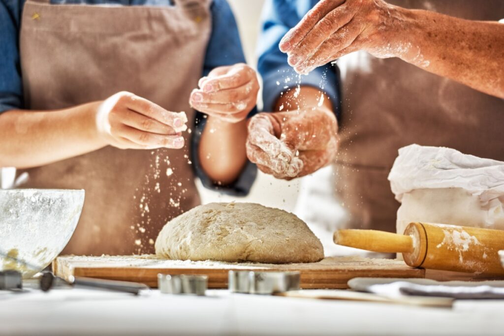 baker's hands making homemade bread