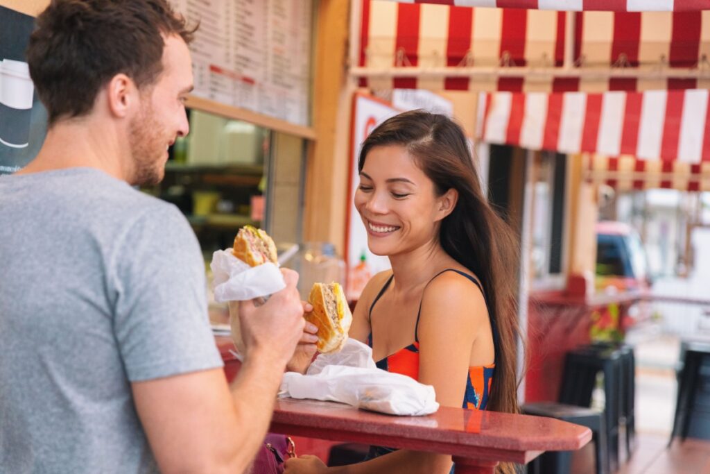 couple eating Miami Cuban sandwich shop