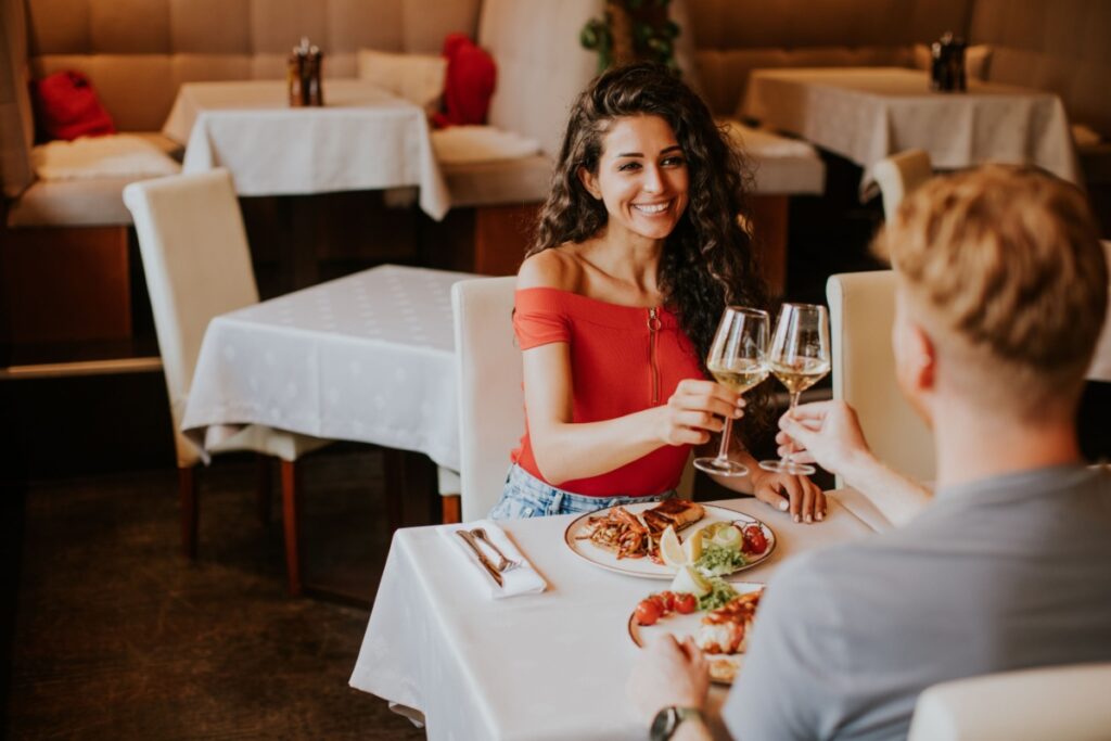 couple on romantic date wine cheers