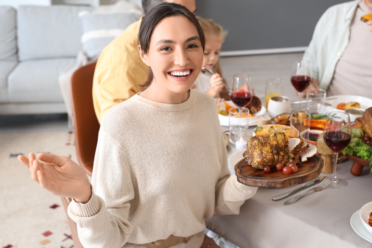 family dinner at festive table on Thanksgiving Day