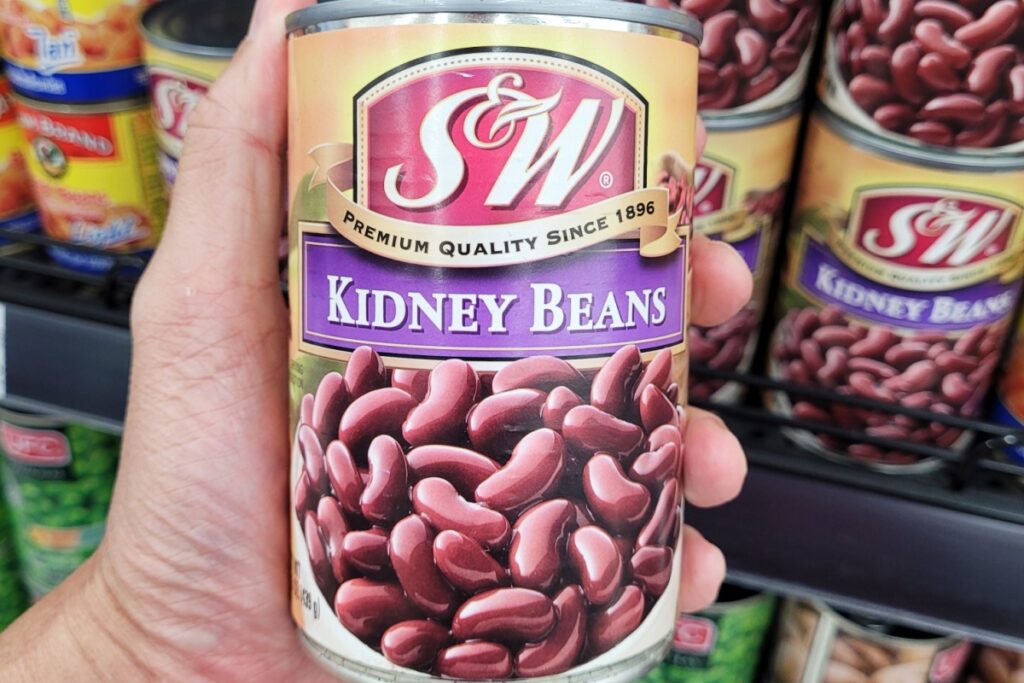 hand holding can of kidney beans